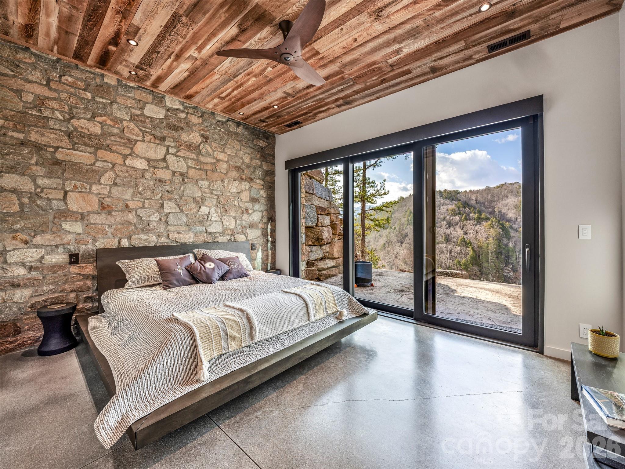 112 Moon Shadow Lane Marshall, NC 28753 - Photo 34 of 48 a bedroom with a large bed and a large window