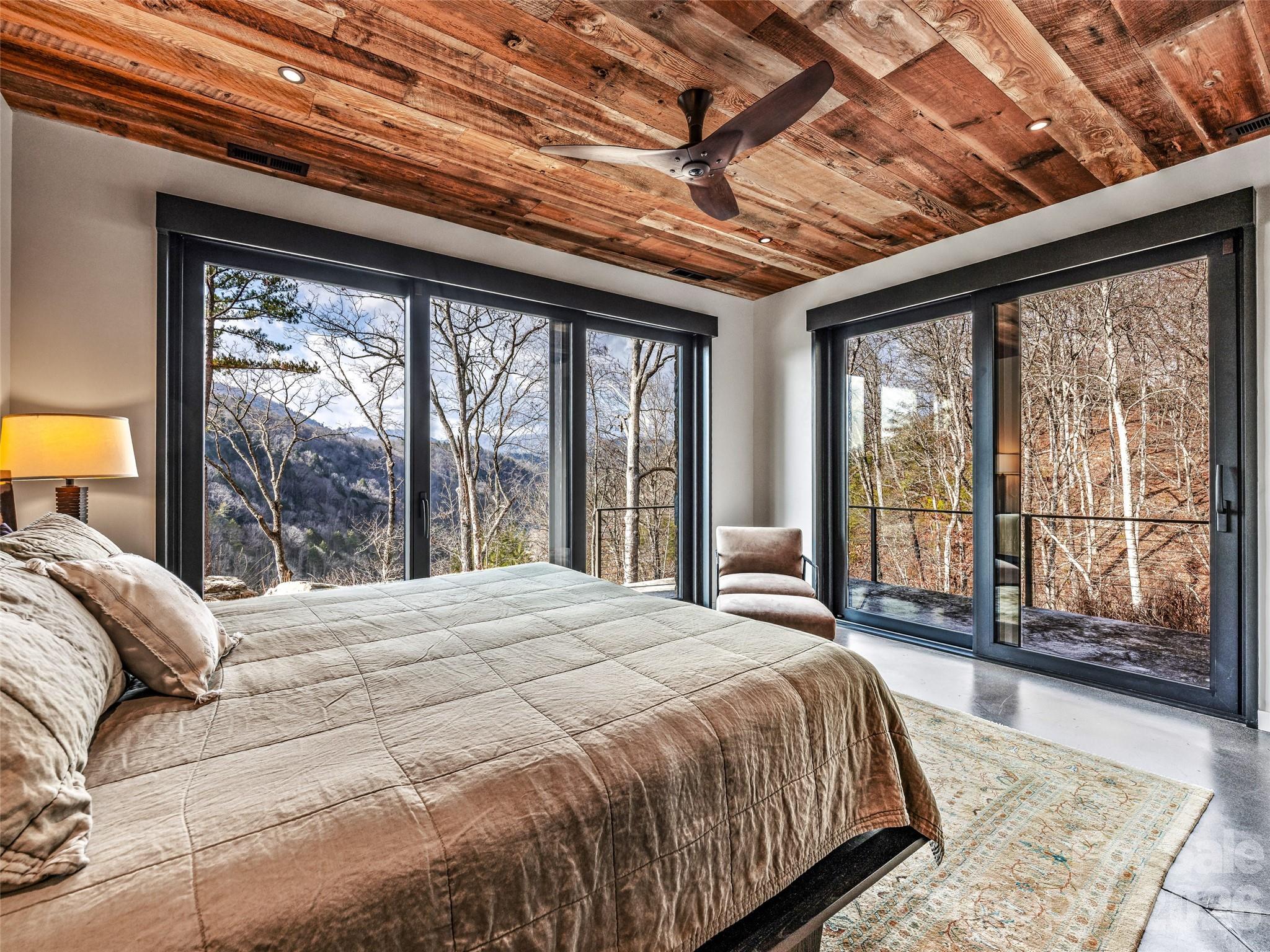 112 Moon Shadow Lane Marshall, NC 28753 - Photo 35 of 48 a large bed sitting in a bedroom next to a large window