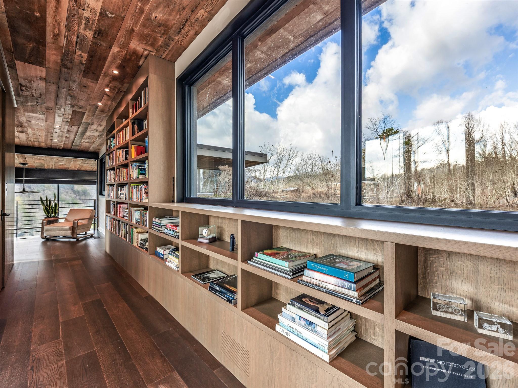 112 Moon Shadow Lane Marshall, NC 28753 - Photo 39 of 48 a living room with furniture a large window and wooden floor