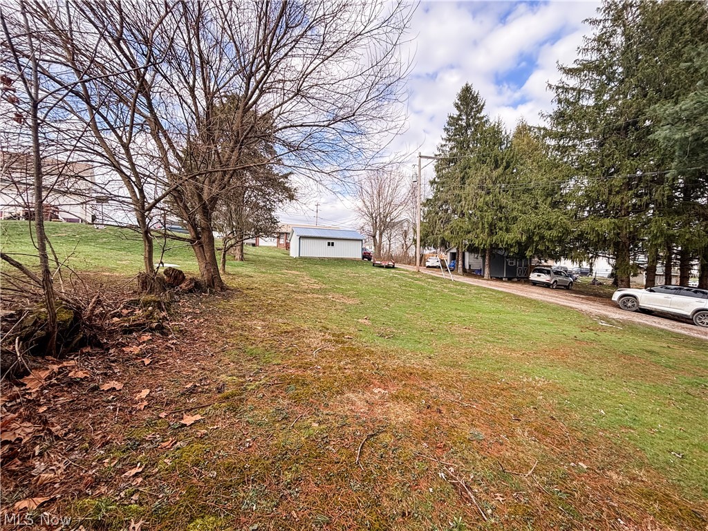724 East Main Street Barnesville, OH 43713 - Photo 6 of 28 View of grassy yard with an outdoor structure
