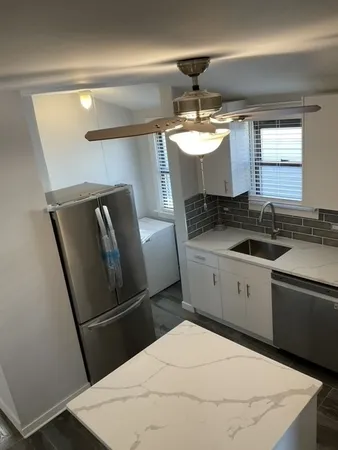 a kitchen with a refrigerator and a sink