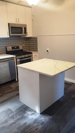 a close view of kitchen island with wooden floor