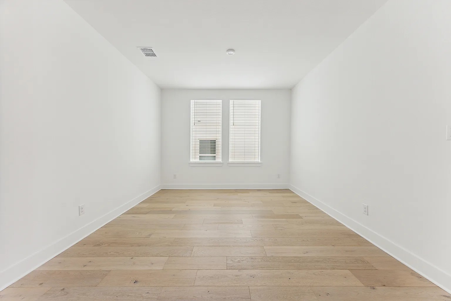 1909 Varese Path Leander, TX 78641 - Photo 24 of 40 Naturally illuminated, this versatile room boasts warm wood flooring, offering endless possibilities.