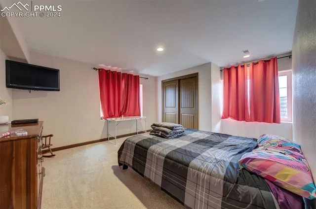 a bedroom with a bed and a television