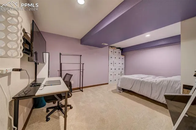 a bedroom with a bed a desk and chair