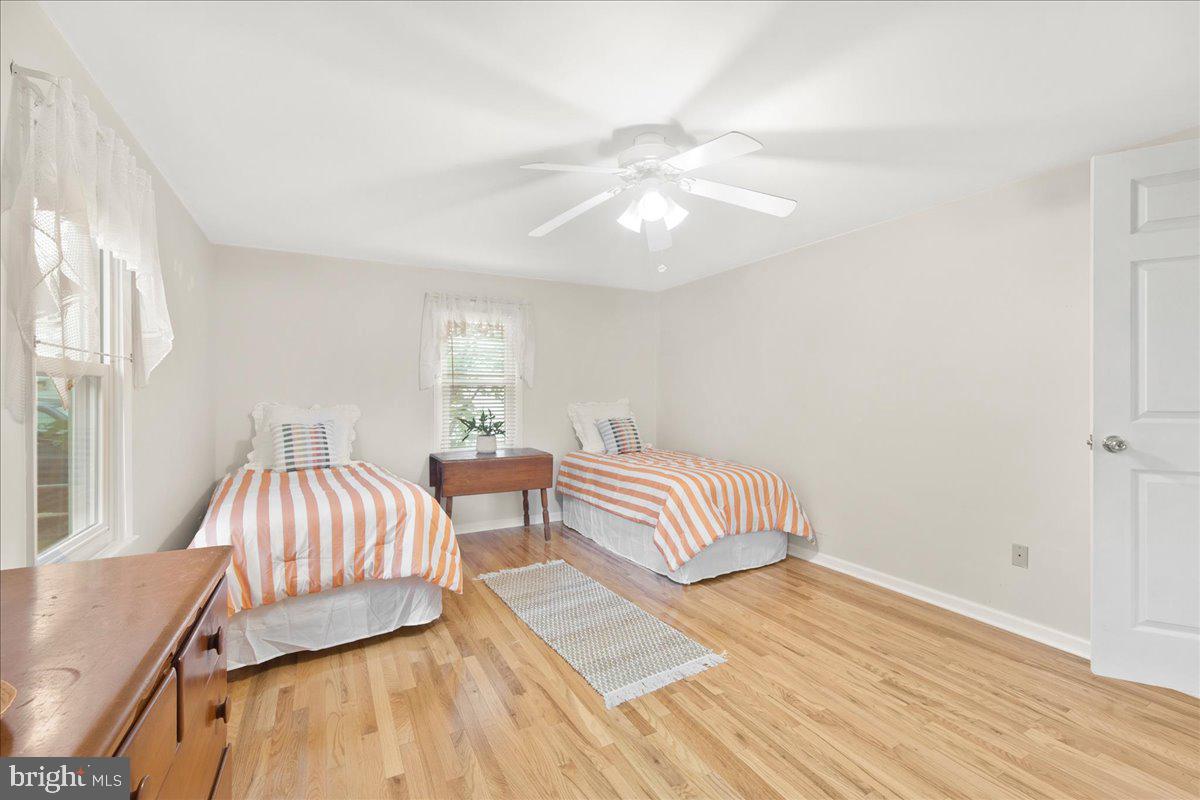 24524 Fullbrook Lane Dames Quarter, MD 21821 - Photo 20 of 45 a spacious bedroom with a bed and a chandelier