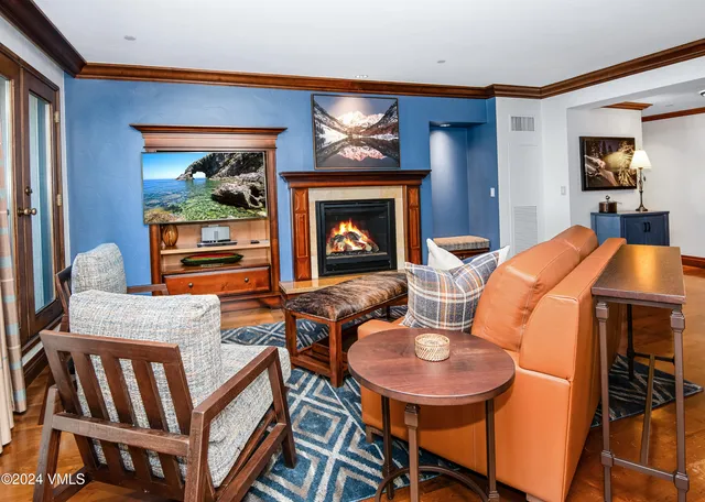 a living room with furniture and a lamp