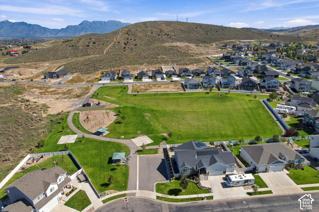 7939 Seattle Slew Road Eagle Mountain, UT 84005 - Photo 48 of 52 Expansive green space featuring a playground, paved walking paths, and shaded picnic areas