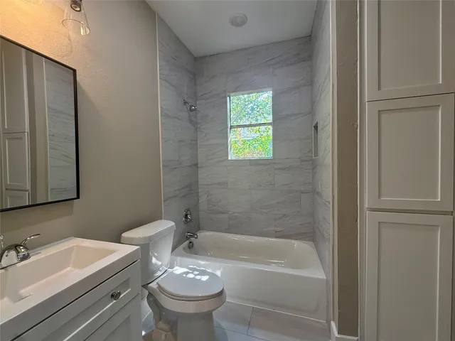 a bathroom with a sink a toilet and a bathtub