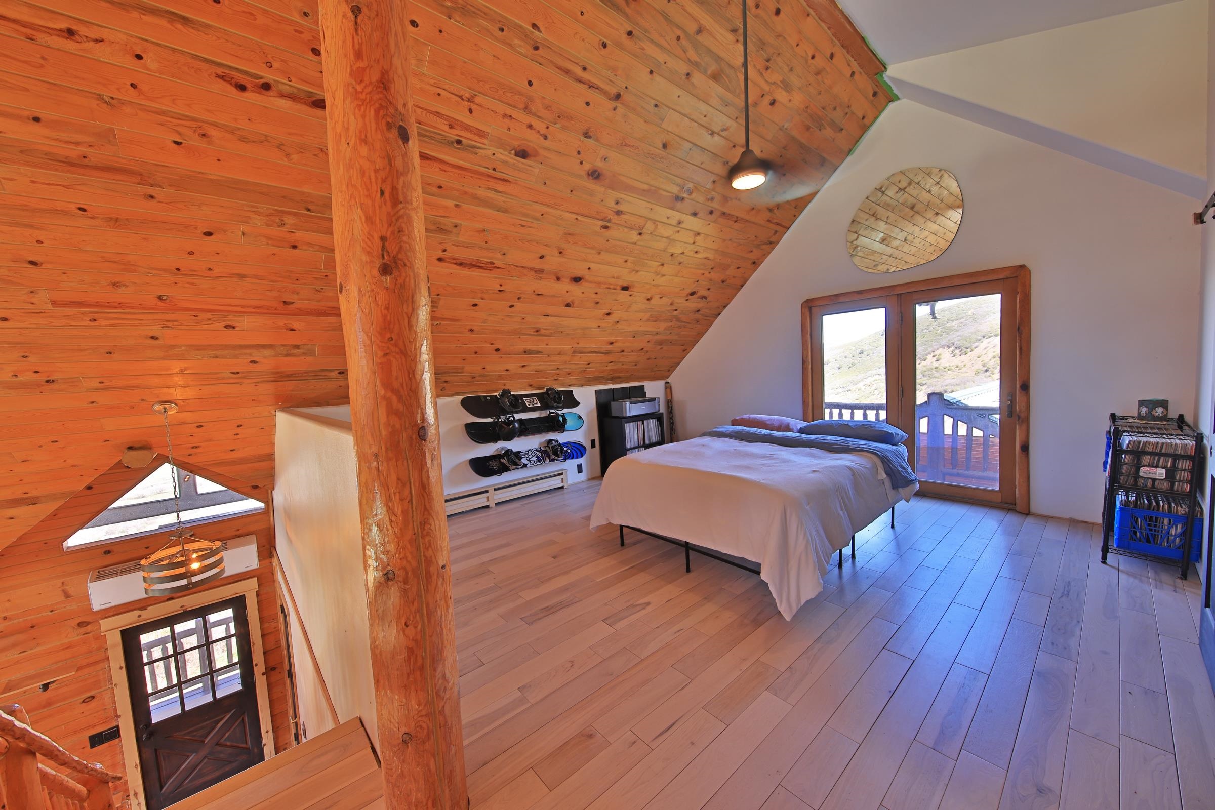 10822-60 60 75/100 Road Collbran, CO 81624 - Photo 19 of 42 a spacious bedroom with a bed and a table with wooden floor