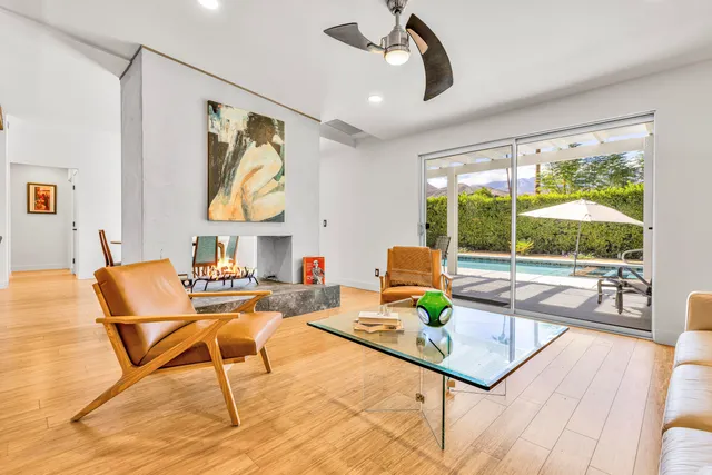 a living room with furniture and a floor to ceiling window
