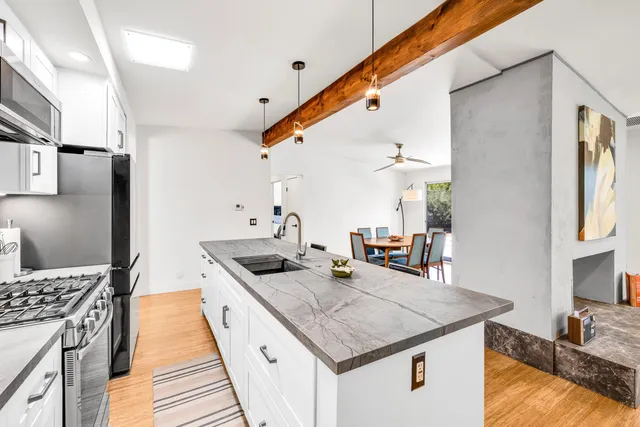 a kitchen with stainless steel appliances granite countertop a sink and stove