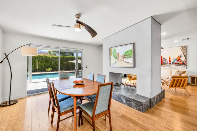 a dining room with furniture a rug and a large window