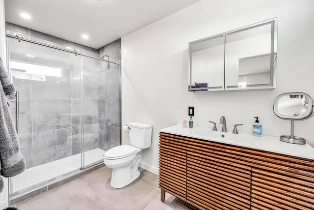 a bathroom with a sink toilet and shower