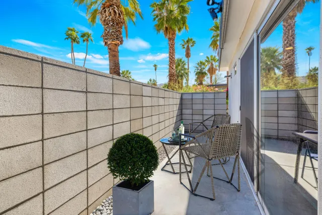 a view of a bench and chair in the patio