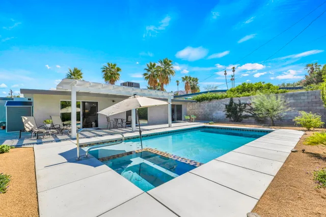 a view of a backyard with plants and patio