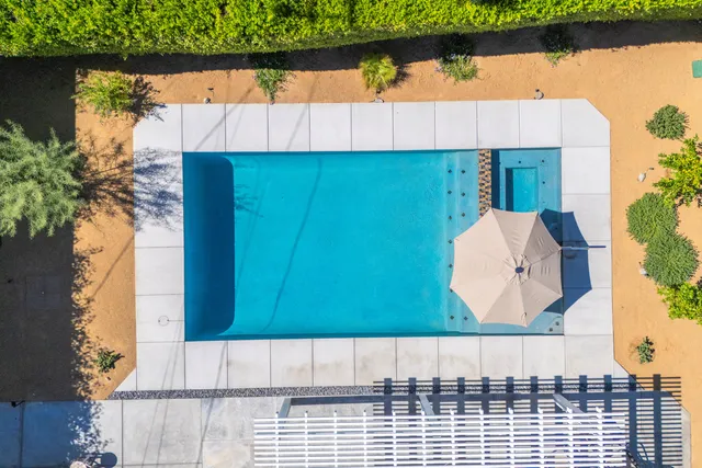 an aerial view of a house with a swimming pool