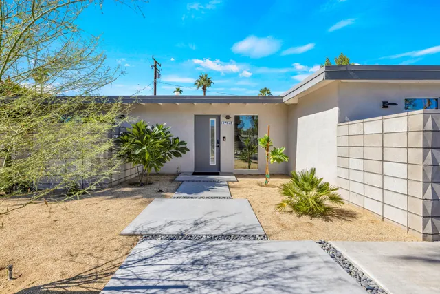 a view of a house with potted plants