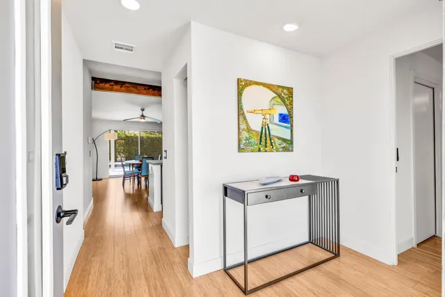 a hallway with a stove and a wooden floor