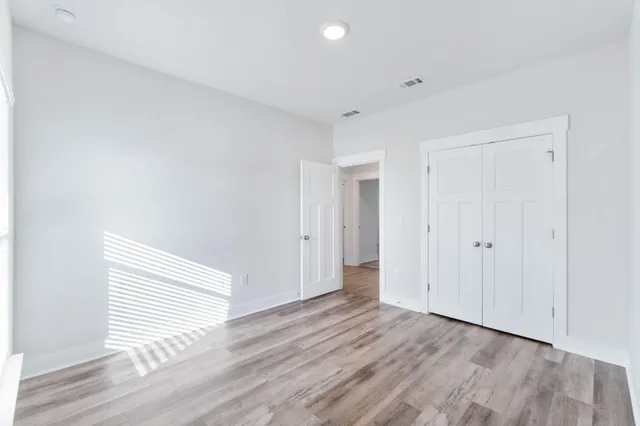 a view of a room with wooden floor and white doors