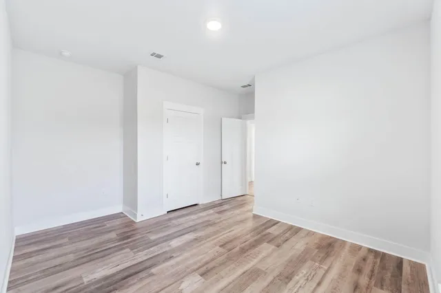 a view of room with wooden floor