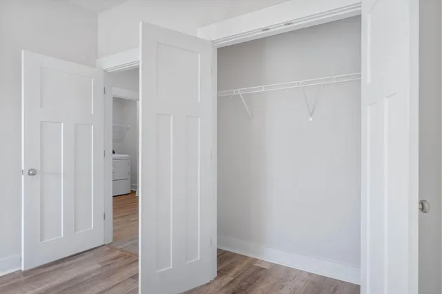 a view of a hallway with wooden floor