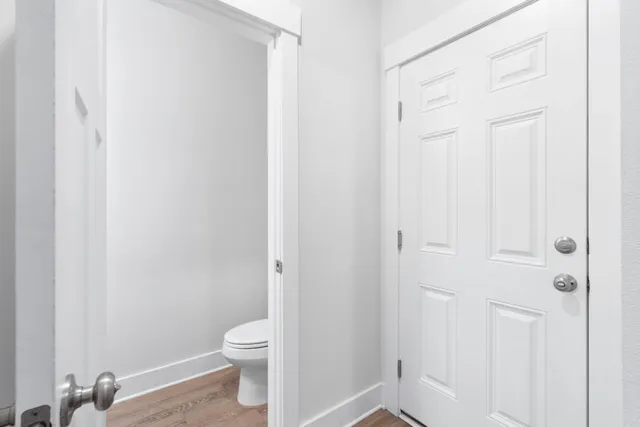 a bathroom with a granite countertop toilet and a sink