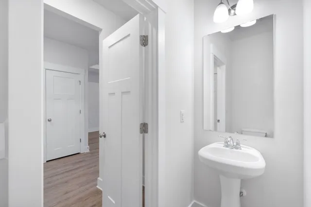 a bathroom with a sink a mirror and a shower