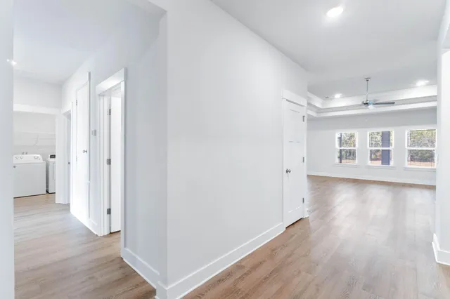 a view of a big room with wooden floor and a bathroom