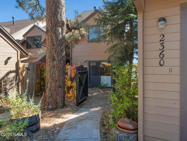 a view of a house with a yard and plants