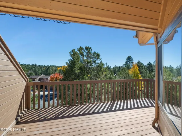 a view of balcony with wooden floor and outdoor seating