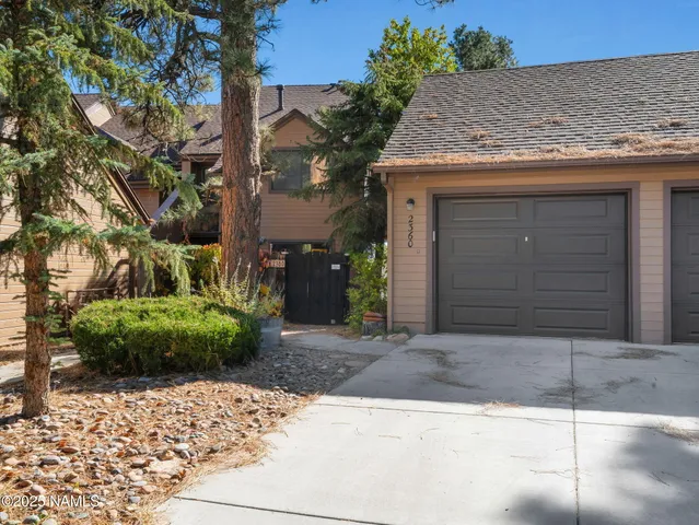a stone house with tree in front of it