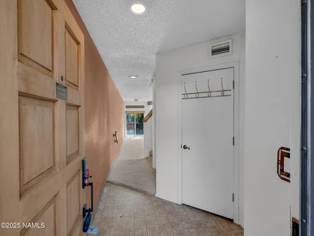 a view of a hallway with staircase