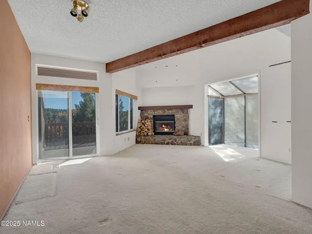 a view of a livingroom with furniture and a fireplace