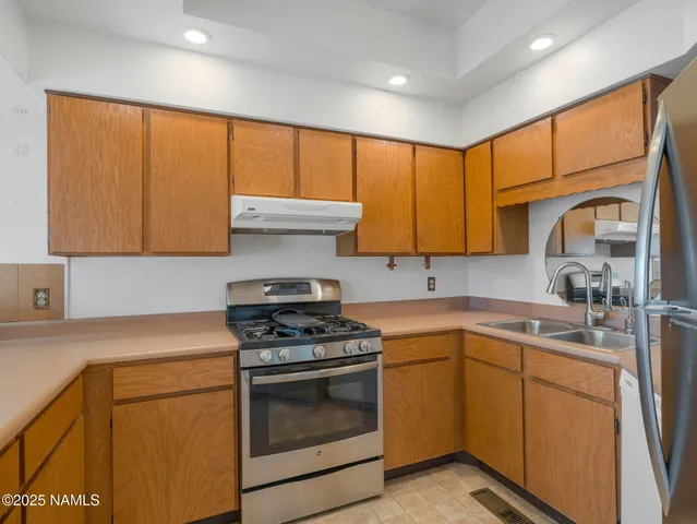 a kitchen with a sink stove and cabinets