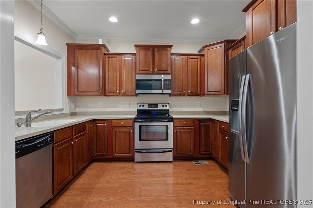 930 Westland Ridge Road Fayetteville, NC 28311 - Photo 11 of 50 a kitchen with stainless steel appliances granite countertop a refrigerator stove and sink