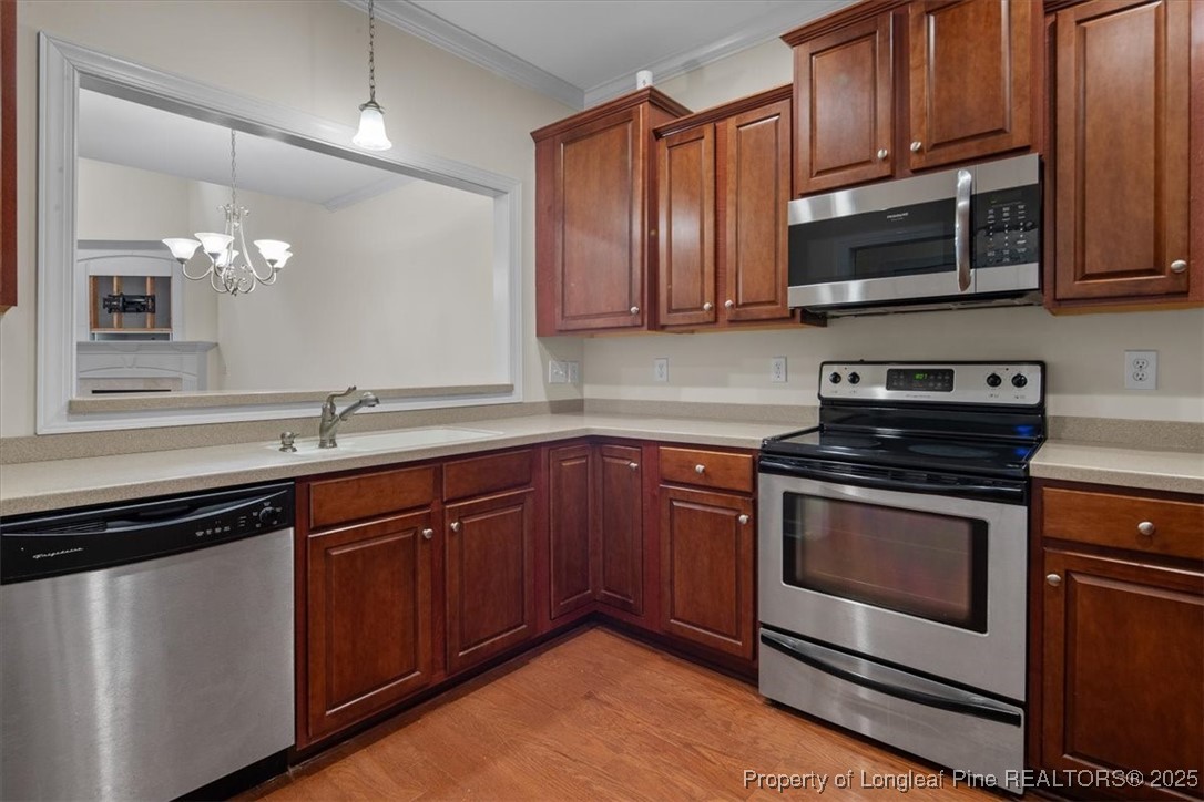 930 Westland Ridge Road Fayetteville, NC 28311 - Photo 13 of 50 a kitchen with granite countertop wood cabinets stainless steel appliances and a sink