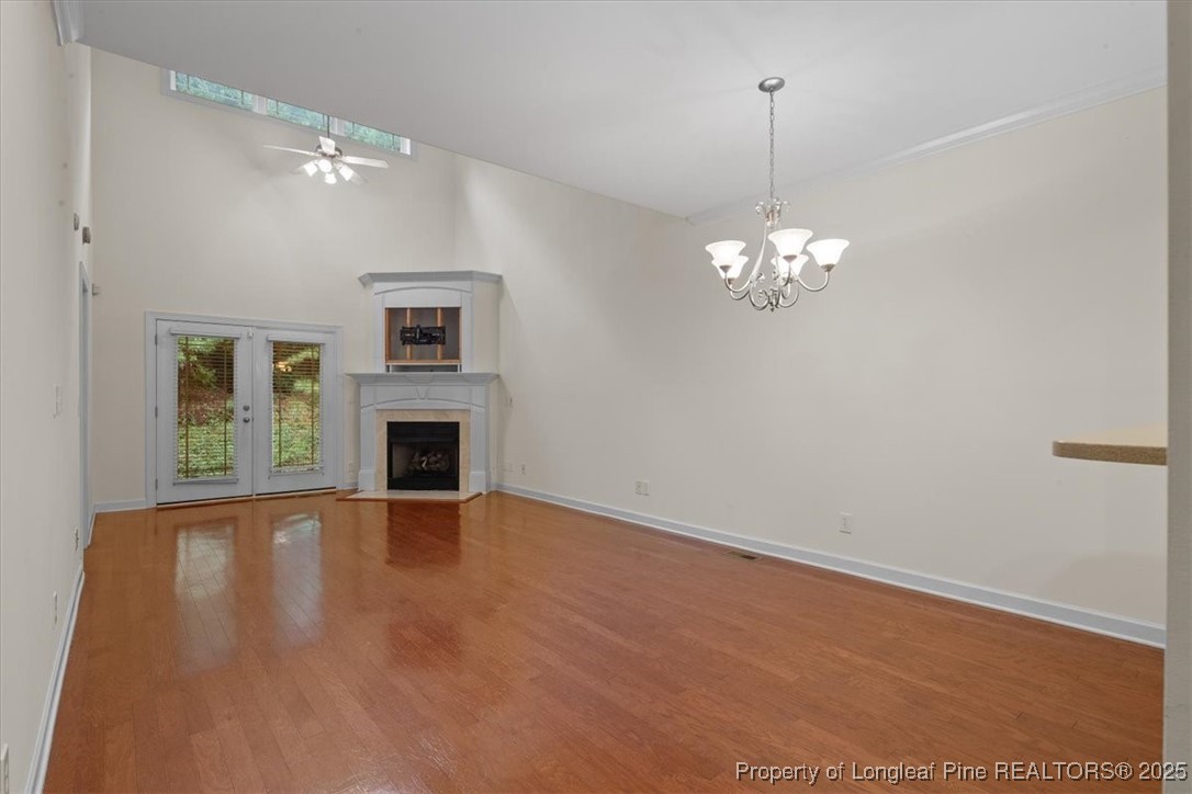 930 Westland Ridge Road Fayetteville, NC 28311 - Photo 16 of 50 a view of a livingroom with a fireplace a chandelier and wooden floor