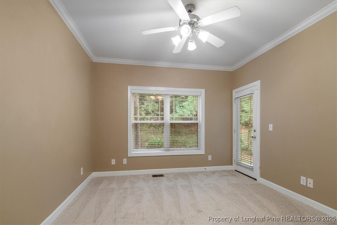 930 Westland Ridge Road Fayetteville, NC 28311 - Photo 24 of 50 an empty room with chandelier fan and windows