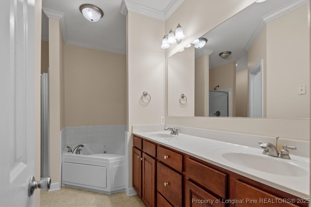 930 Westland Ridge Road Fayetteville, NC 28311 - Photo 25 of 50 a bathroom with a tub double sink and mirror