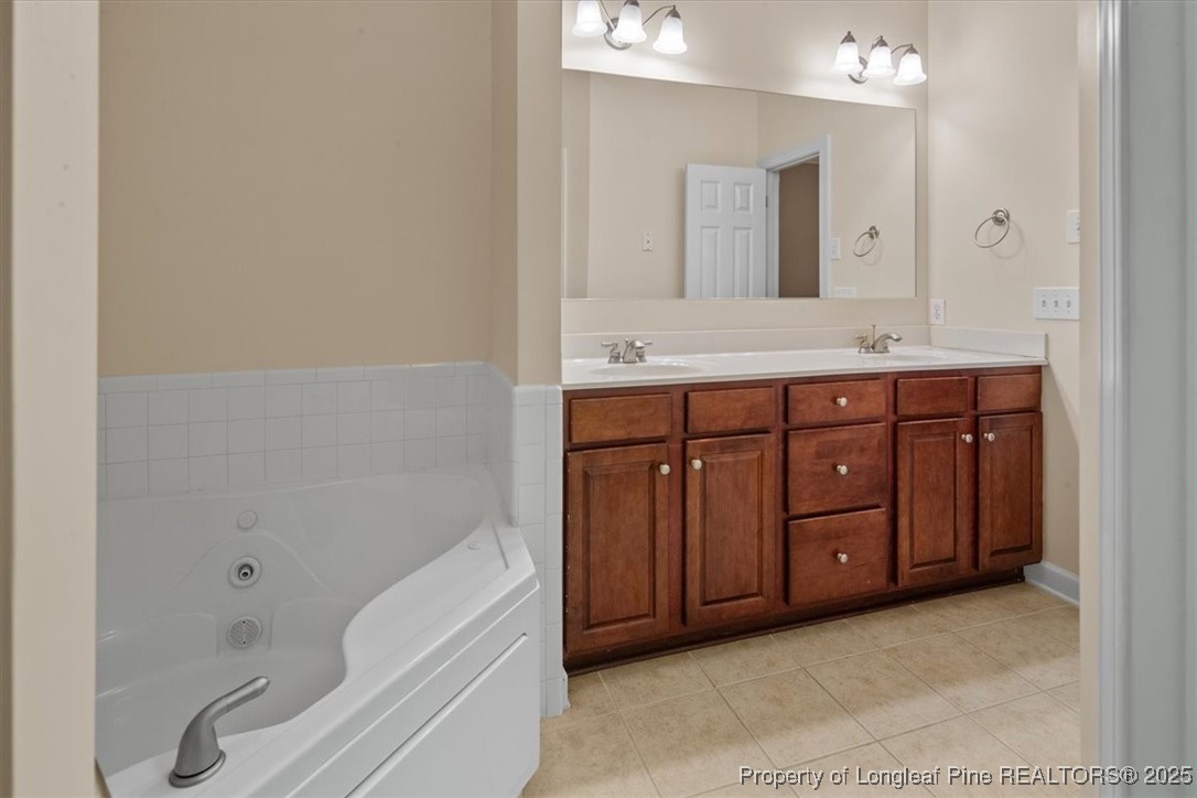 930 Westland Ridge Road Fayetteville, NC 28311 - Photo 29 of 50 a spacious bathroom with a tub sink and mirror