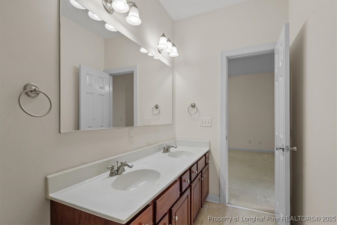 930 Westland Ridge Road Fayetteville, NC 28311 - Photo 40 of 50 a bathroom with a sink vanity and a mirror