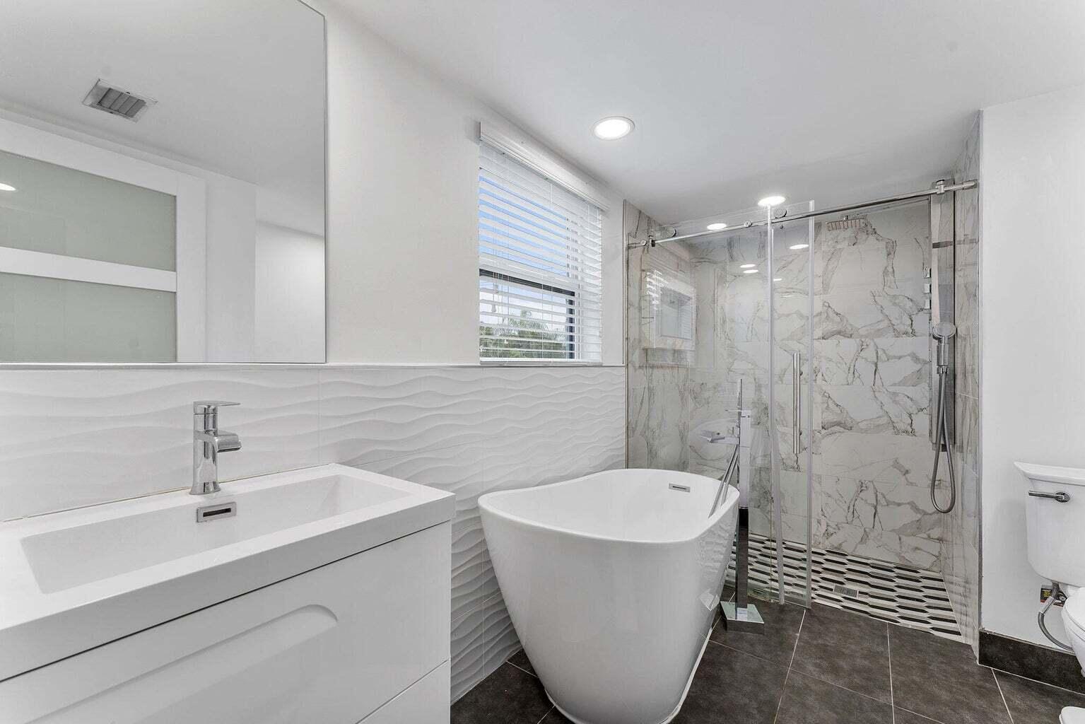 6031 Northwest 4th Avenue Boca Raton, FL 33487 - Photo 19 of 36 a bathroom with a sink and a mirror