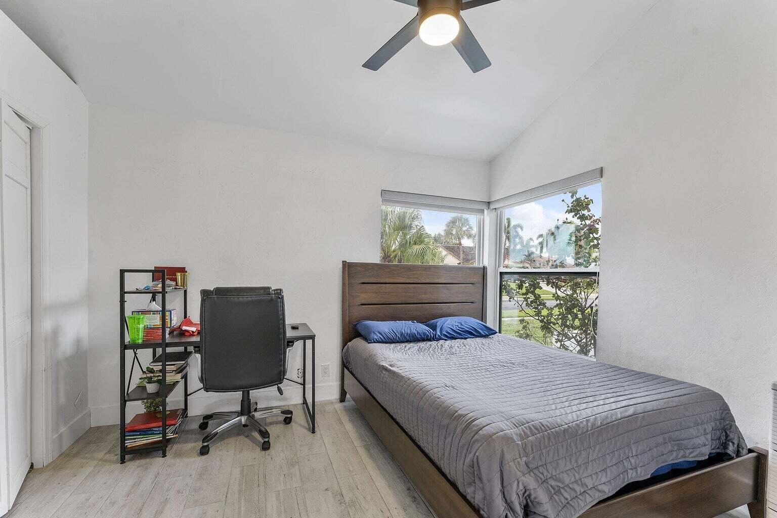 6031 Northwest 4th Avenue Boca Raton, FL 33487 - Photo 20 of 36 a bedroom with a bed and a window