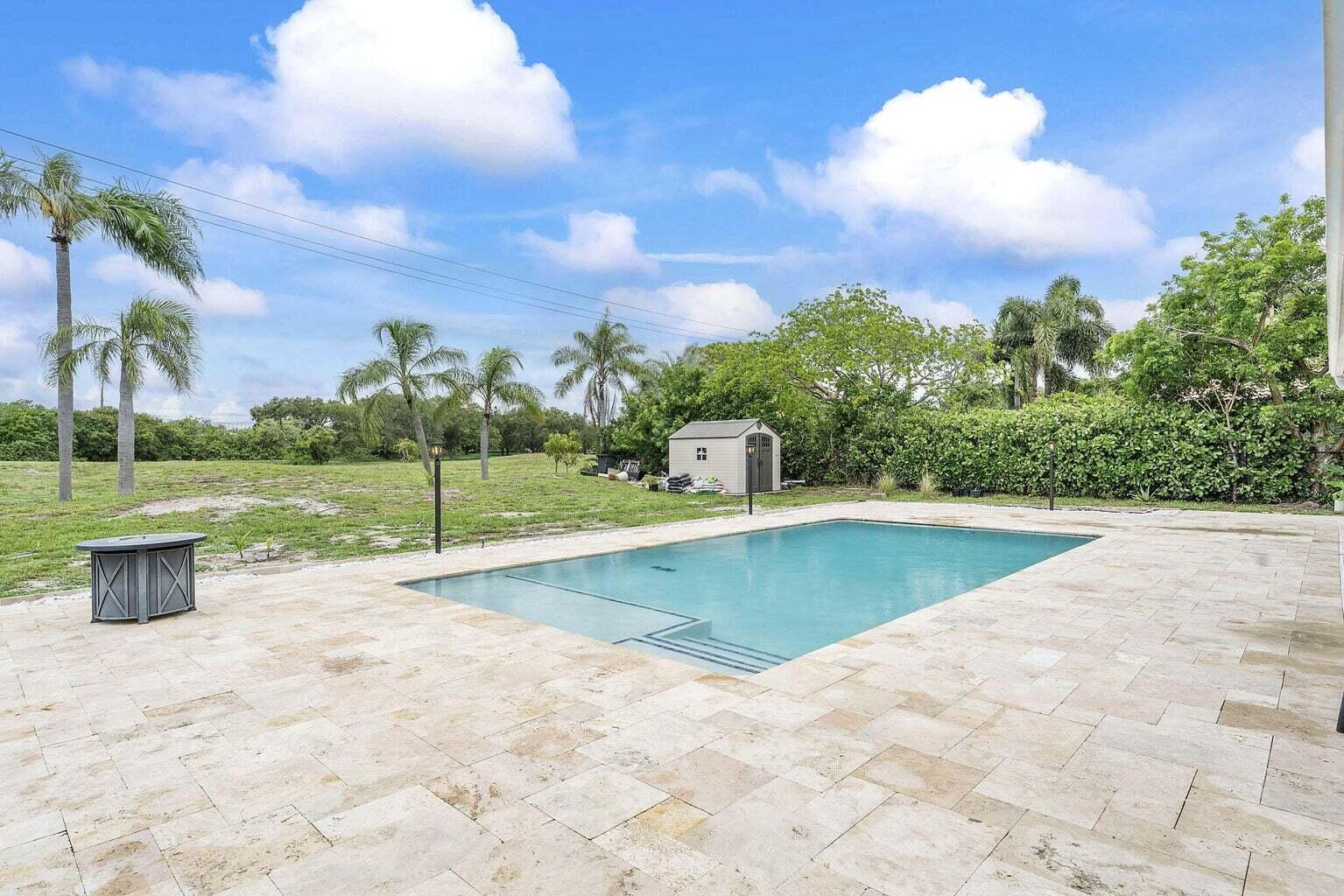 6031 Northwest 4th Avenue Boca Raton, FL 33487 - Photo 30 of 36 a view of a swimming pool with a yard