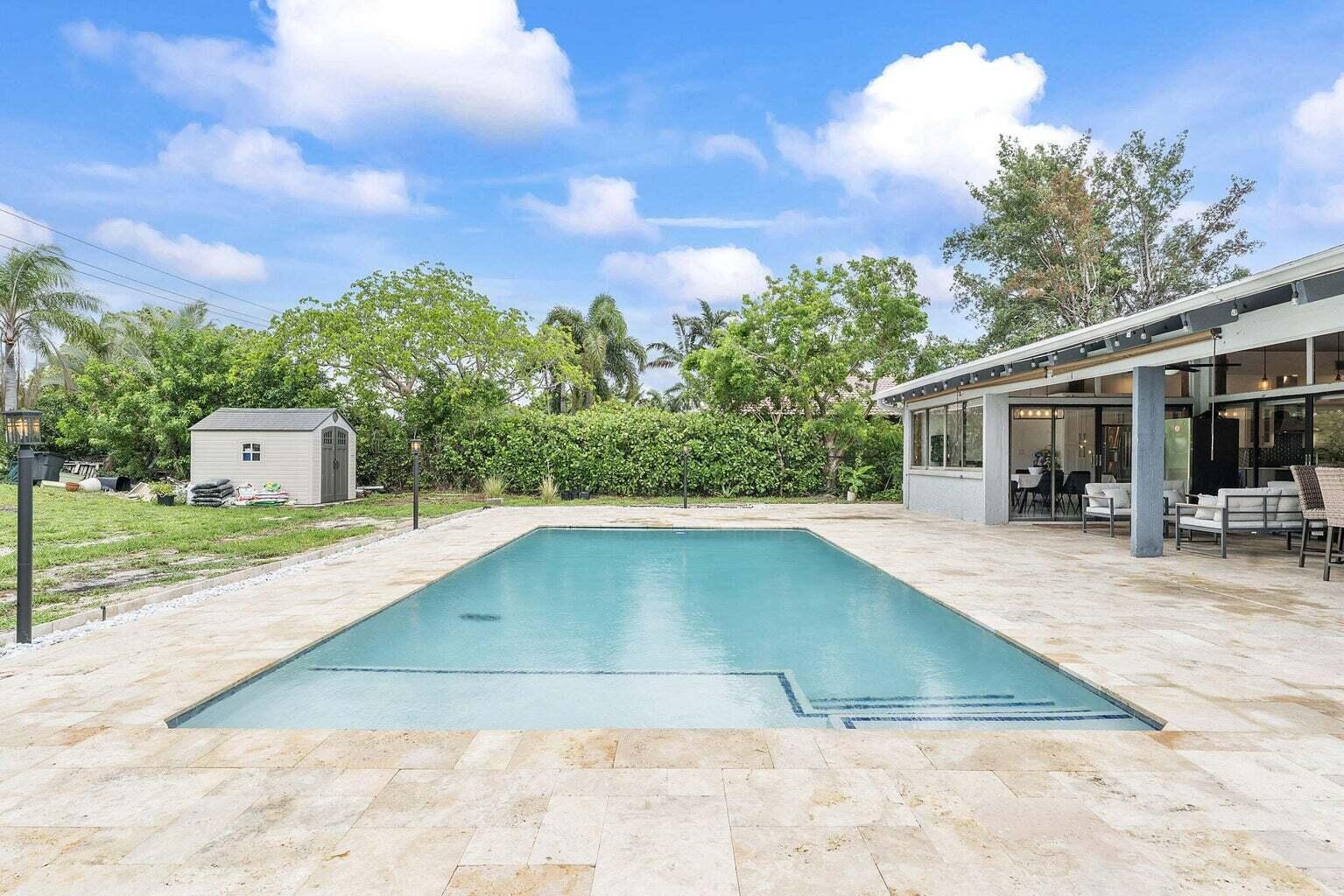 6031 Northwest 4th Avenue Boca Raton, FL 33487 - Photo 31 of 36 a view of a swimming pool with a patio