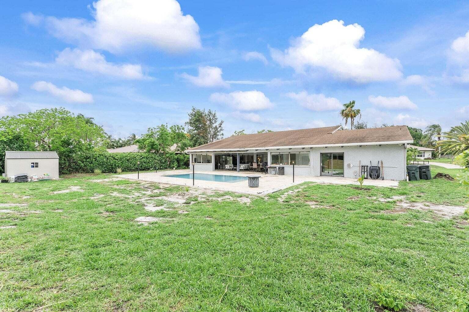 6031 Northwest 4th Avenue Boca Raton, FL 33487 - Photo 33 of 36 a front view of a house with garden