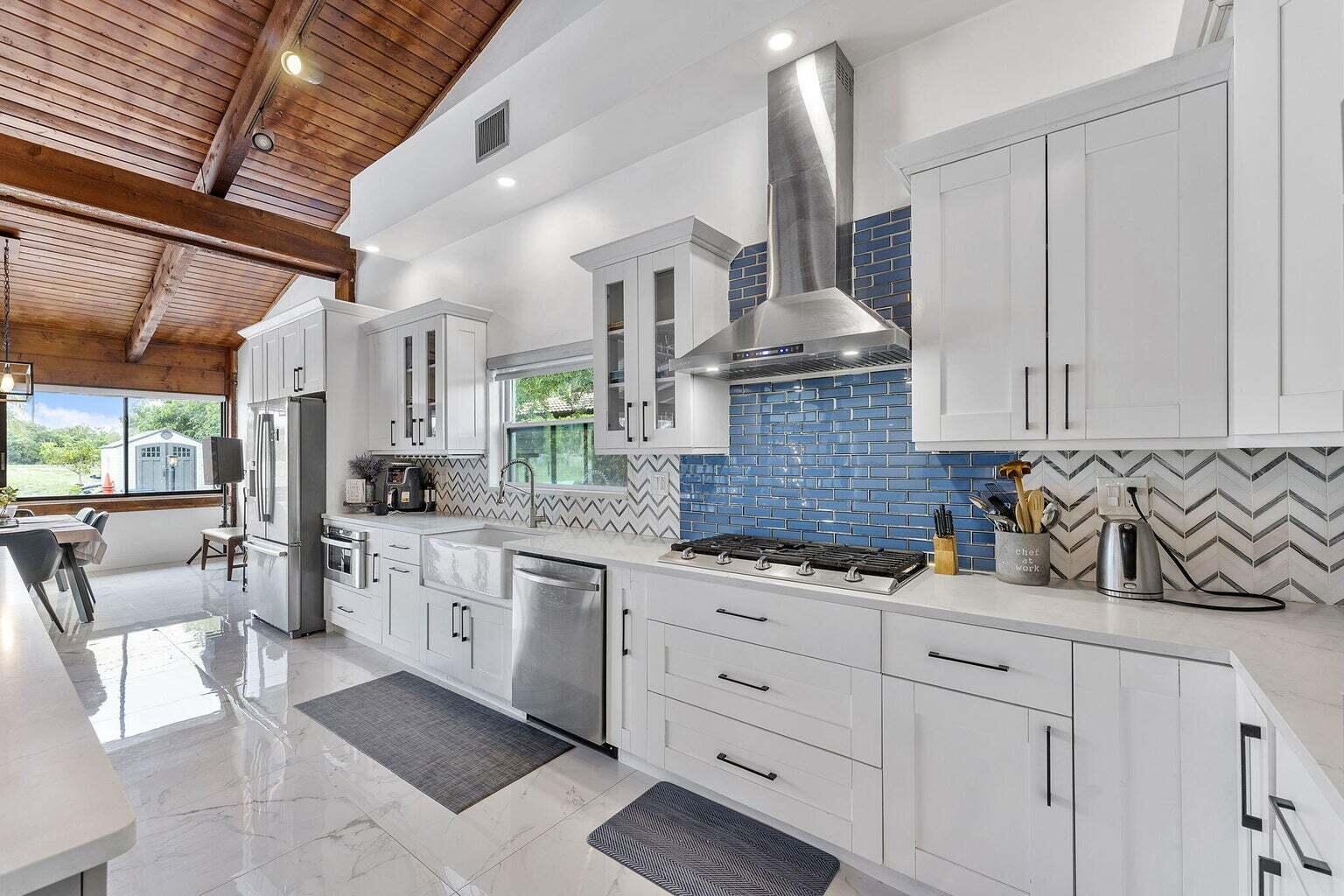 6031 Northwest 4th Avenue Boca Raton, FL 33487 - Photo 7 of 36 a kitchen with stainless steel appliances granite countertop a sink and cabinets