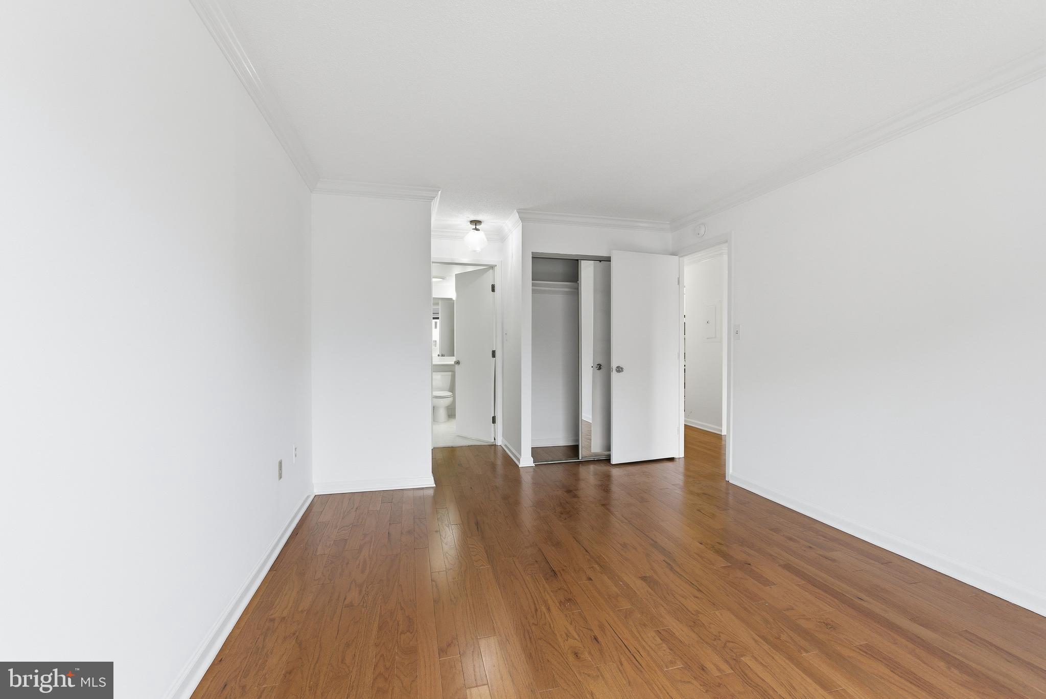 2111 Wisconsin Avenue Northwest, Unit 514 Washington, DC 20007 - Photo 3 of 17 a view of an empty room with wooden floor