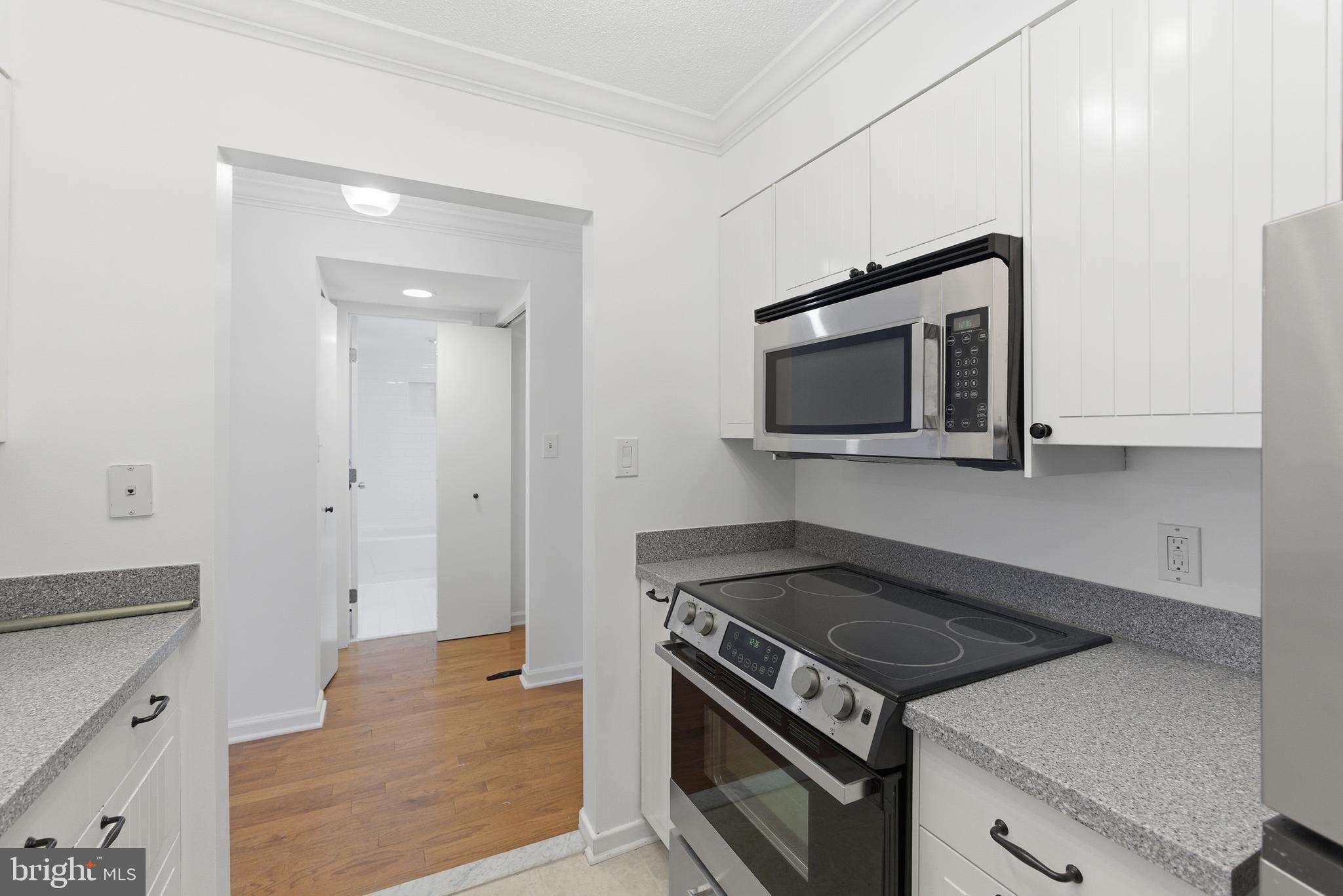 2111 Wisconsin Avenue Northwest, Unit 514 Washington, DC 20007 - Photo 9 of 17 a kitchen with a stove and a microwave